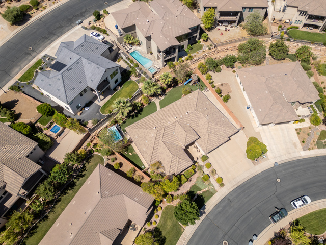 1257 West 2320 South St. George, UT 84770 - Photo 50 of 55 Expansive residential property featuring a large backyard with a rectangular swimming pool, mature landscaping, and a circular driveway