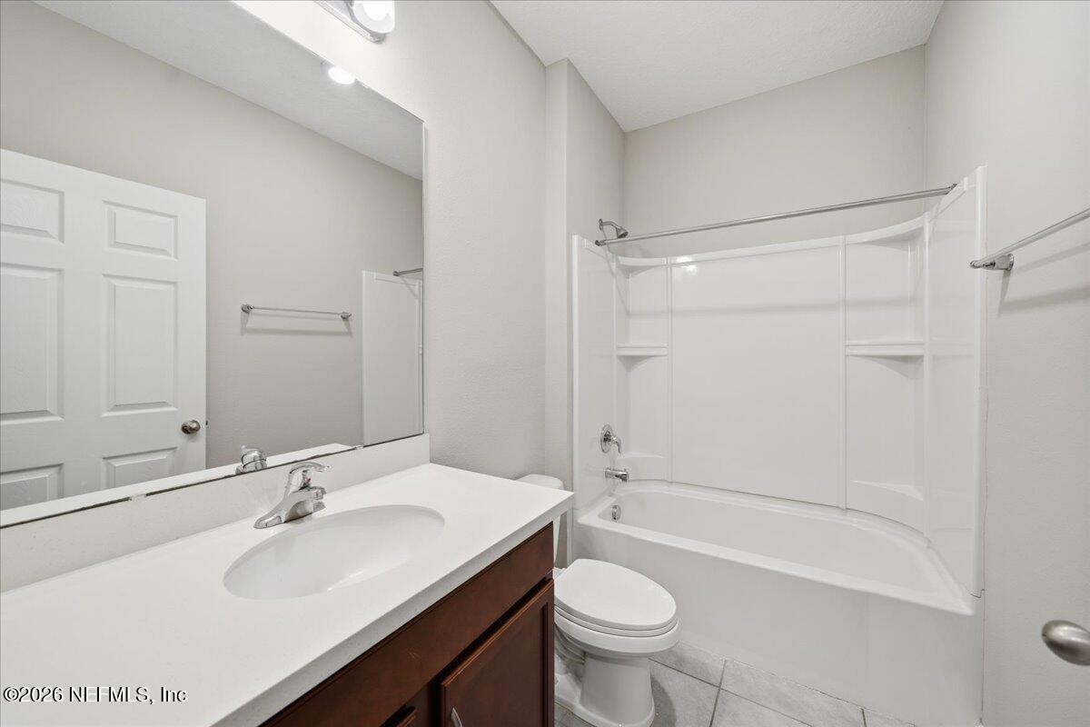 12032 Bridgehampton Road Jacksonville, FL 32218 - Photo 11 of 52 a bathroom with a sink a toilet and shower