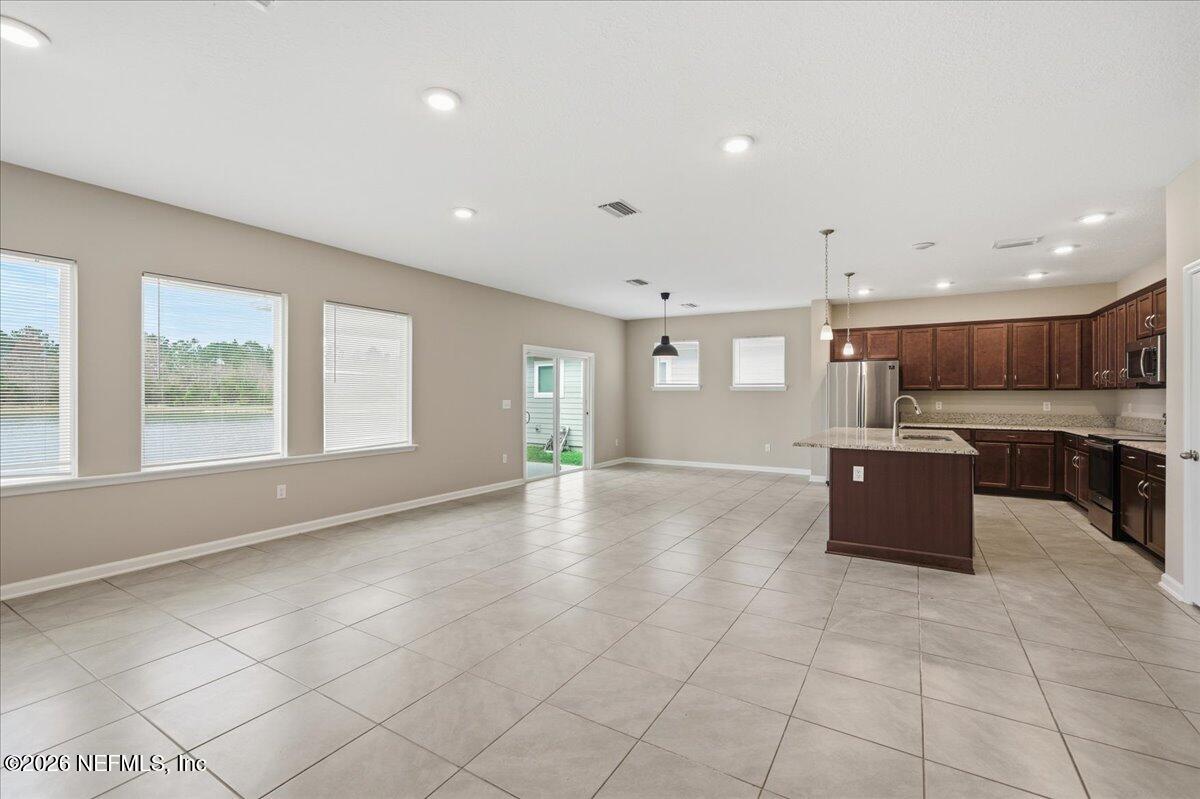 12032 Bridgehampton Road Jacksonville, FL 32218 - Photo 18 of 52 a view of an empty room with kitchen and window