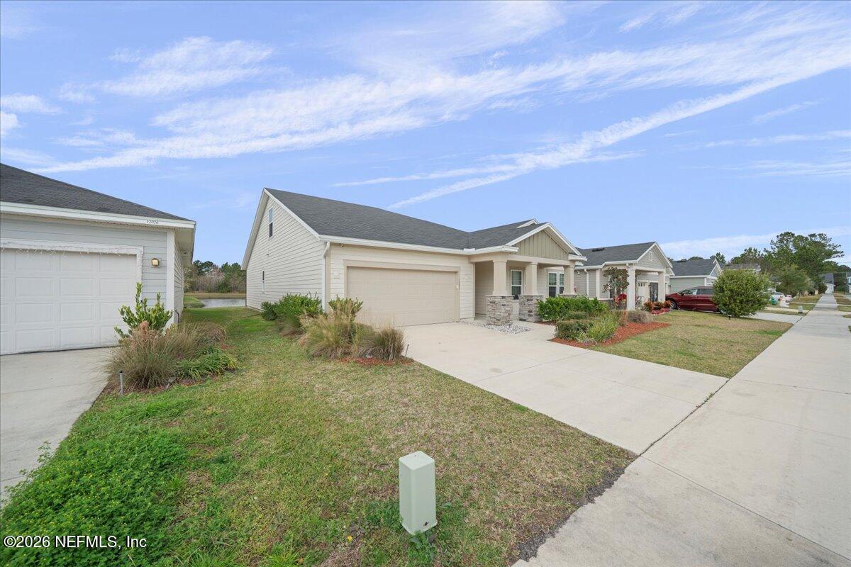 12032 Bridgehampton Road Jacksonville, FL 32218 - Photo 2 of 52 a front view of a house with garden
