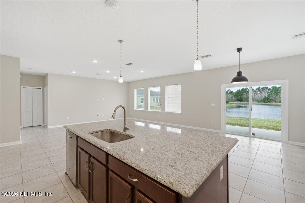 12032 Bridgehampton Road Jacksonville, FL 32218 - Photo 25 of 52 a kitchen with granite countertop a sink a counter top space and cabinets