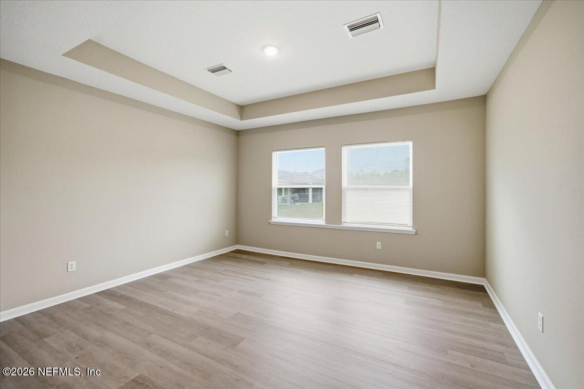 12032 Bridgehampton Road Jacksonville, FL 32218 - Photo 26 of 52 wooden floor in an empty room with a window