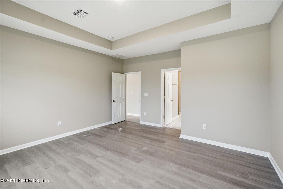 12032 Bridgehampton Road Jacksonville, FL 32218 - Photo 27 of 52 a view of an empty room with wooden floor