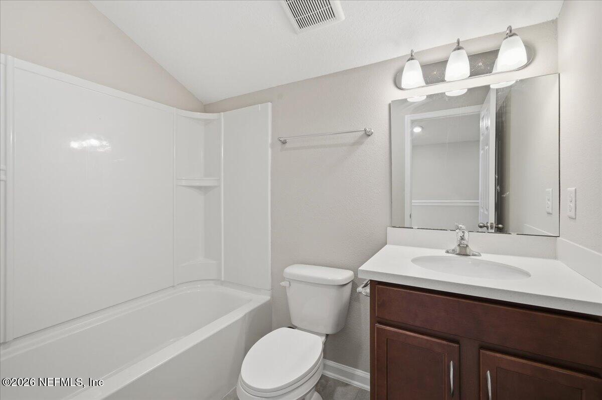 12032 Bridgehampton Road Jacksonville, FL 32218 - Photo 31 of 52 a bathroom with a sink a toilet and shower