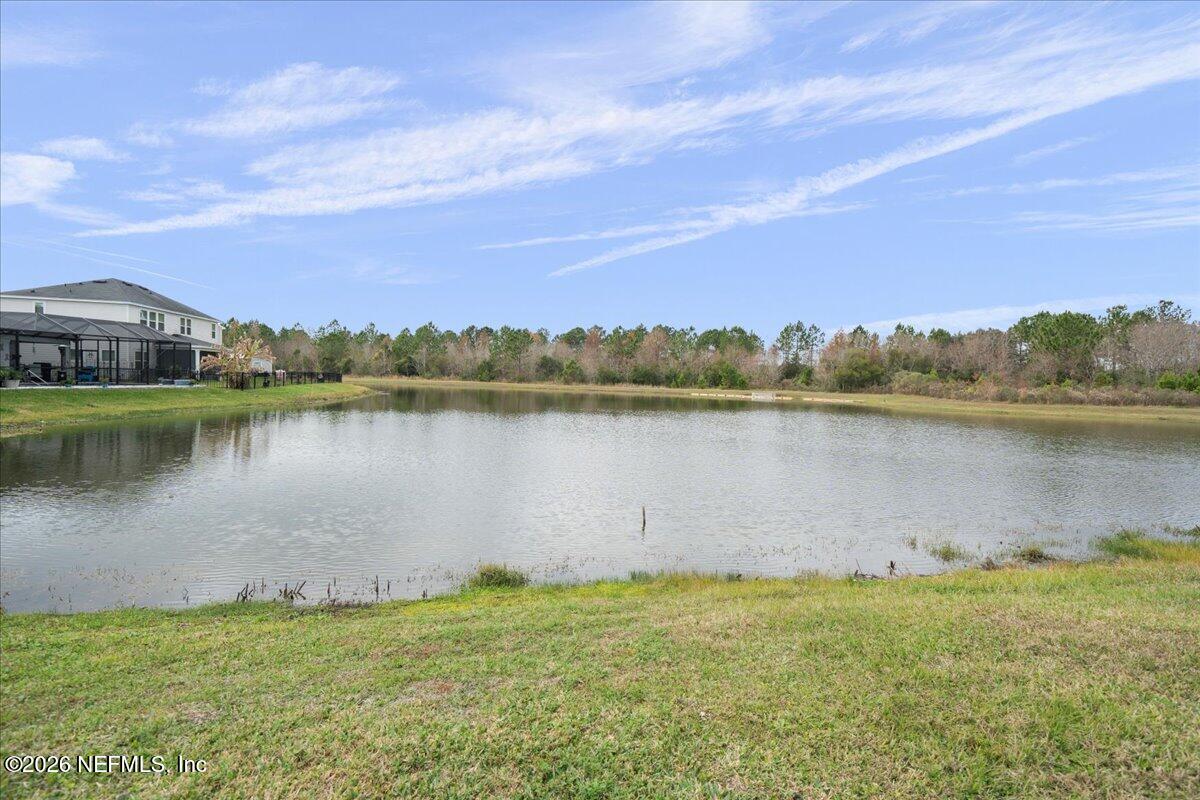 12032 Bridgehampton Road Jacksonville, FL 32218 - Photo 38 of 52 a view of a lake with houses in the back