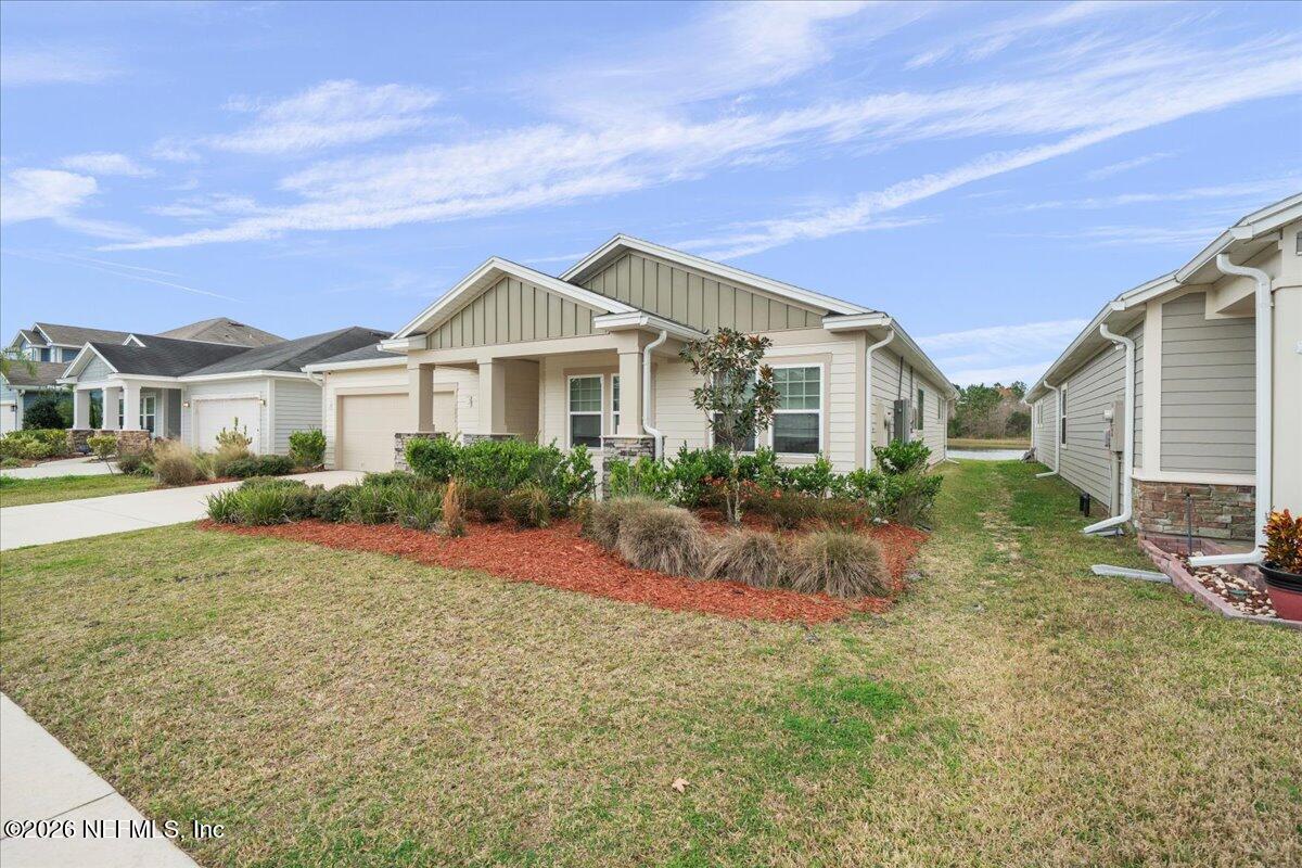 12032 Bridgehampton Road Jacksonville, FL 32218 - Photo 4 of 52 a front view of a house with a yard