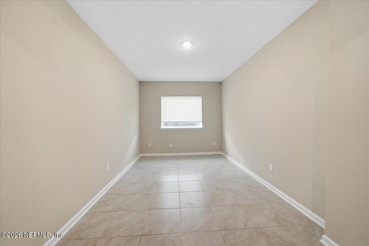 12032 Bridgehampton Road Jacksonville, FL 32218 - Photo 9 of 52 a view of an empty room and window