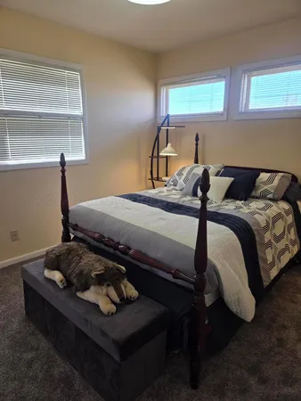 a bedroom with a bed and a window