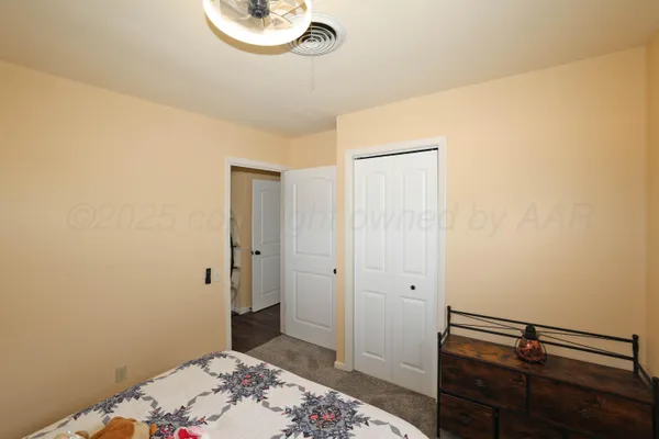 a bedroom with a bed and windows