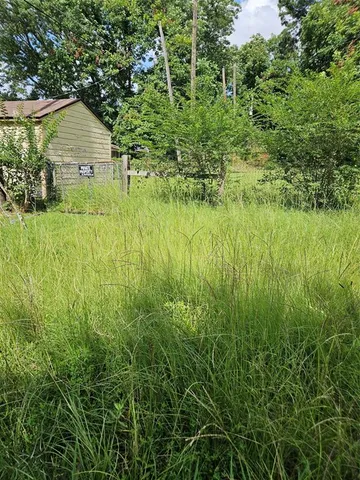 a view of a garden with a house