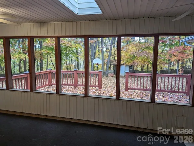 an empty room with wooden floor and a window