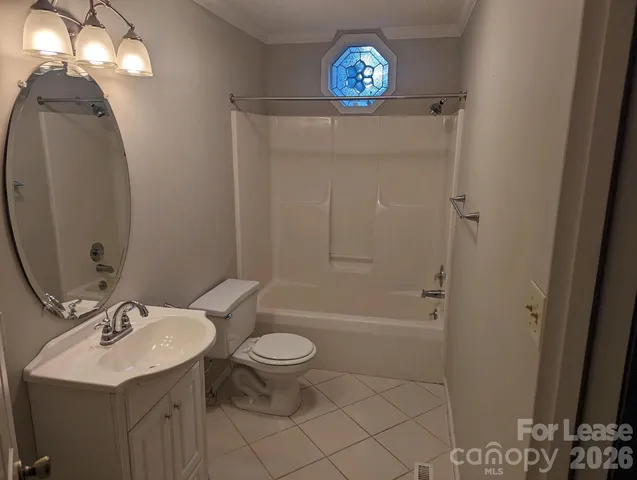 a bathroom with a sink a toilet a mirror and shower