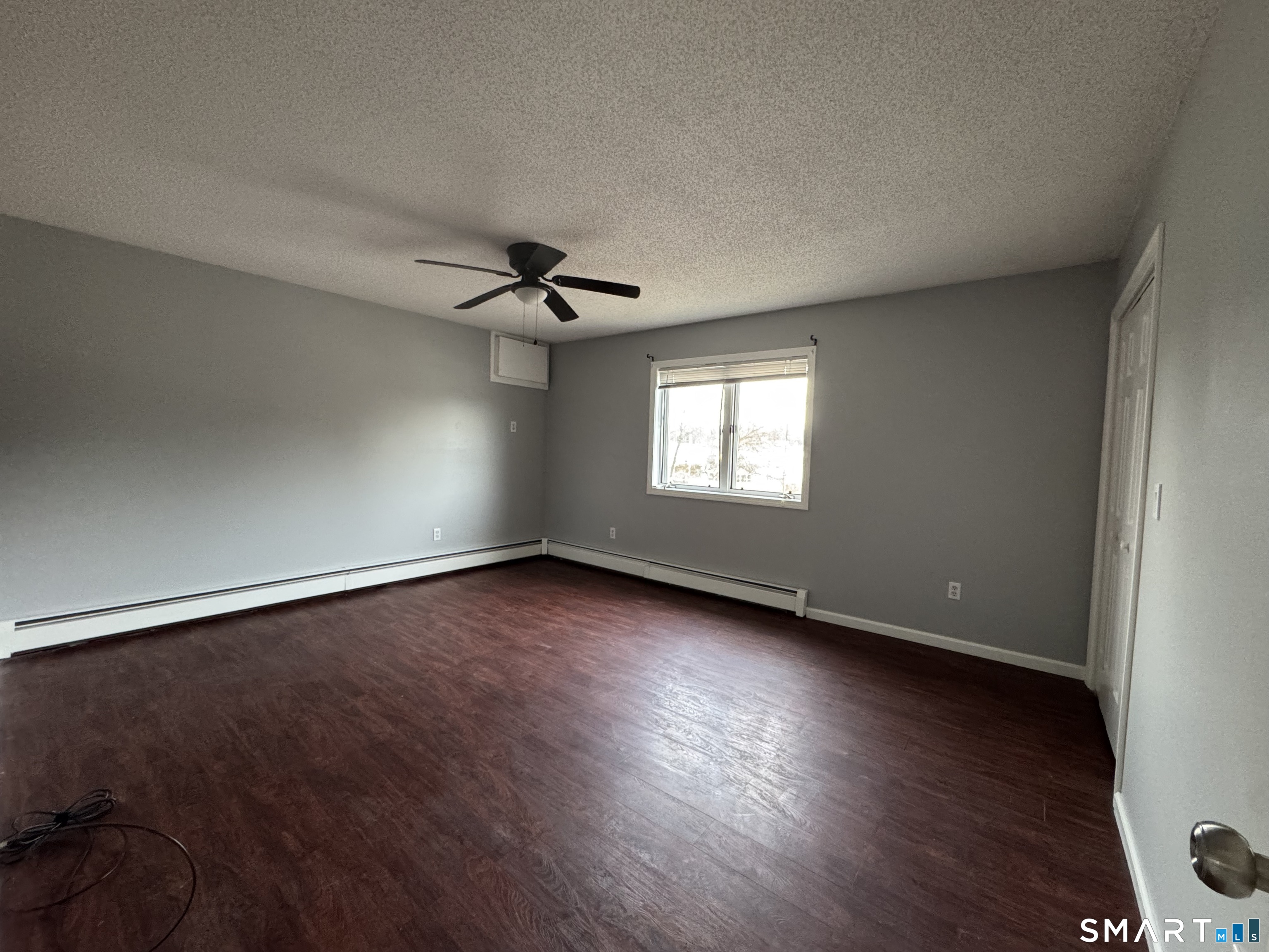 27 Katie Lane Waterbury, CT 06708 - Photo 7 of 14 a view of an empty room with wooden floor and a window