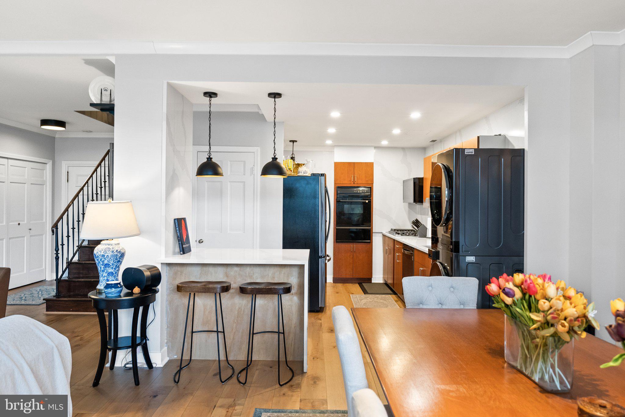2700 Virginia Avenue Northwest, Unit 109 Washington, DC 20037 - Photo 1 of 47 a kitchen with stainless steel appliances kitchen island granite countertop a table and chairs in it