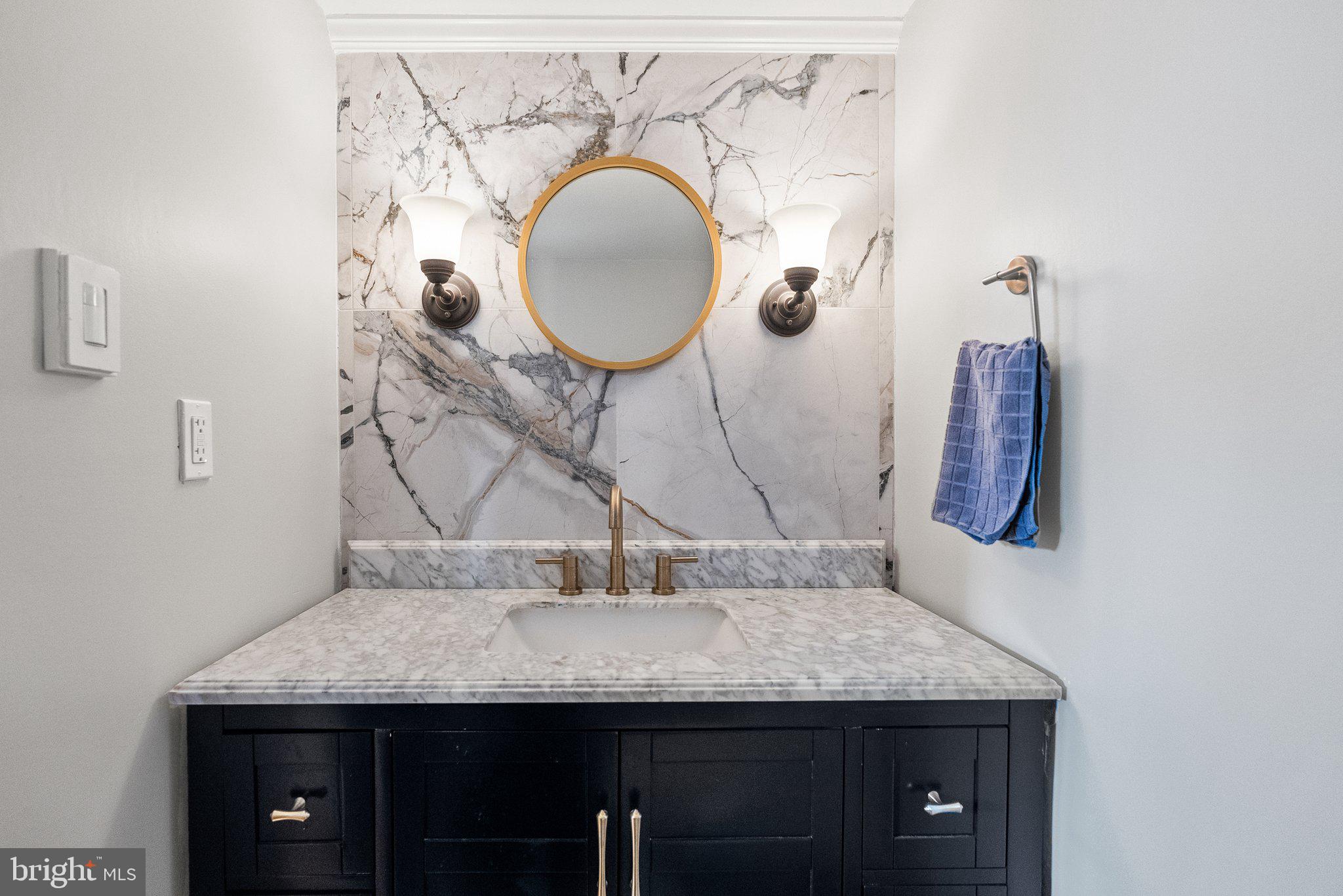 2700 Virginia Avenue Northwest, Unit 109 Washington, DC 20037 - Photo 11 of 47 a bathroom with a granite countertop sink and a mirror