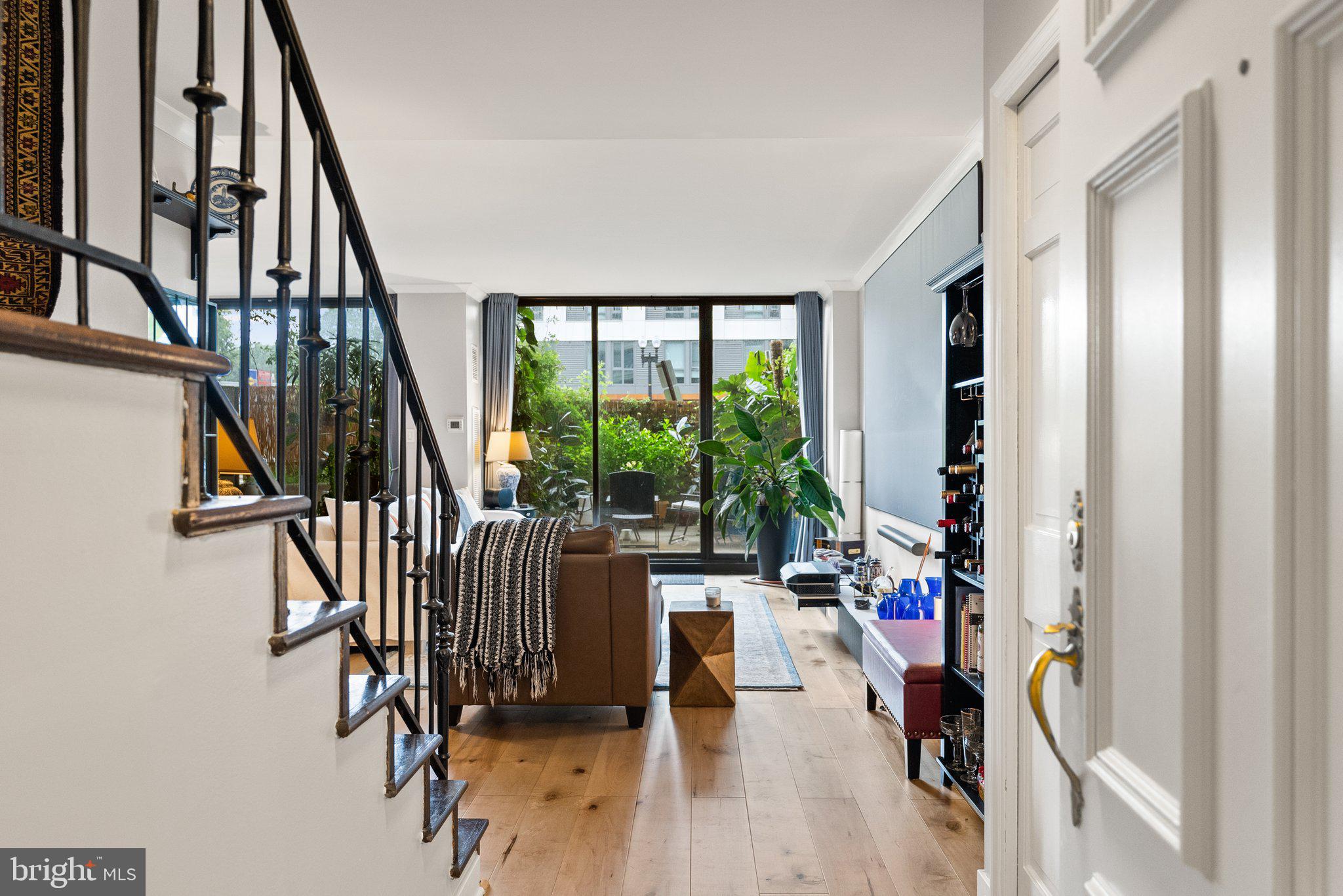 2700 Virginia Avenue Northwest, Unit 109 Washington, DC 20037 - Photo 30 of 47 a view of a livingroom with furniture staircase window and hardwood floor