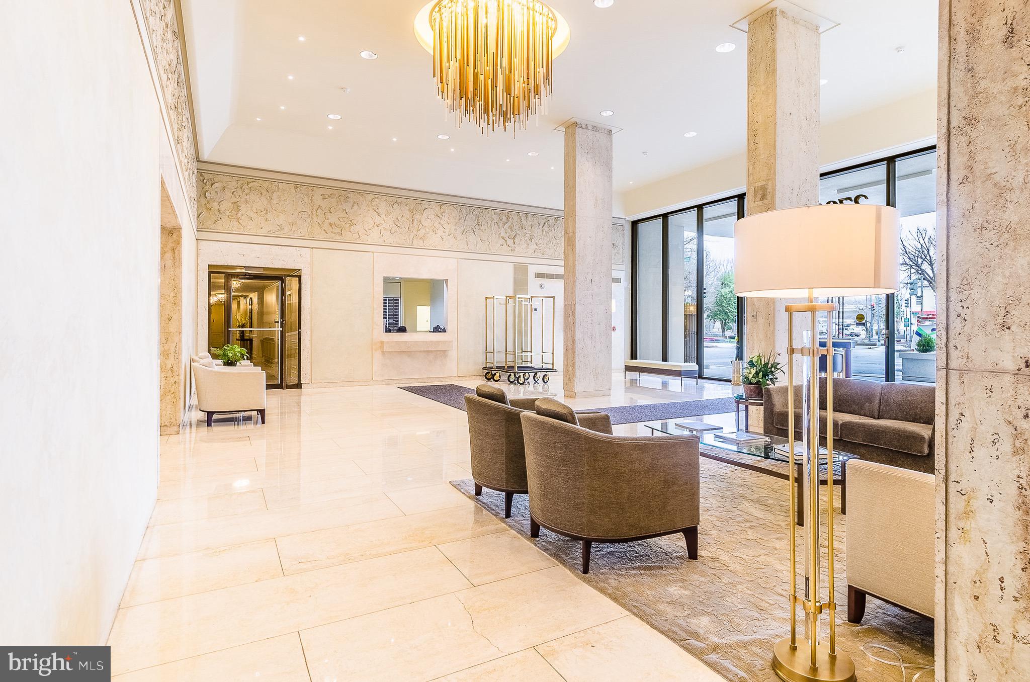2700 Virginia Avenue Northwest, Unit 109 Washington, DC 20037 - Photo 36 of 47 a living room with couches a coffee table and kitchen view with wooden floor