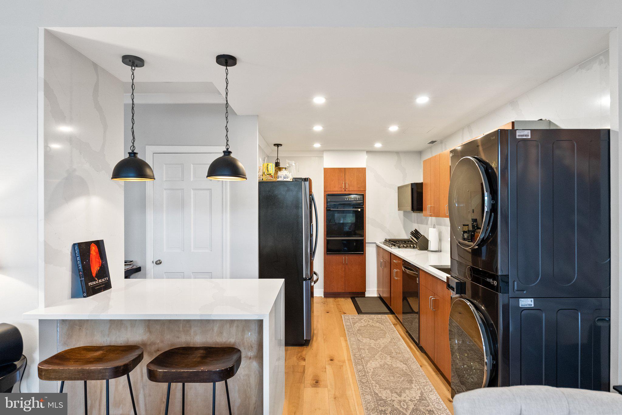 2700 Virginia Avenue Northwest, Unit 109 Washington, DC 20037 - Photo 6 of 47 a kitchen with stainless steel appliances a refrigerator sink and wooden floor