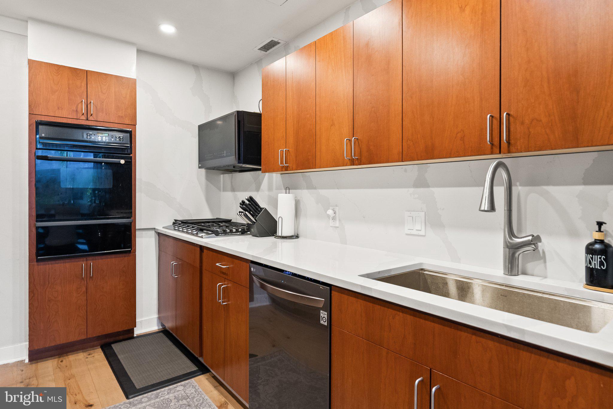 2700 Virginia Avenue Northwest, Unit 109 Washington, DC 20037 - Photo 7 of 47 a kitchen with stainless steel appliances a sink dishwasher a refrigerator and cabinets