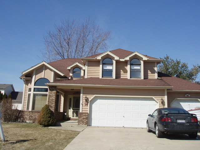 a front view of a house with parking