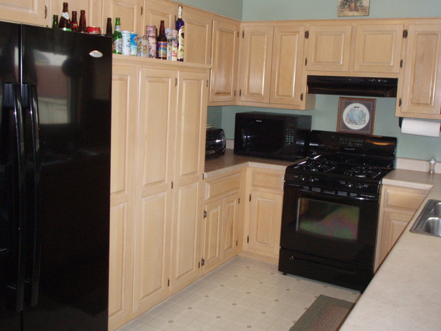 289 Butte View Drive Bolingbrook, IL 60490 - Photo 8 of 19 a kitchen with granite countertop white cabinets and black appliances