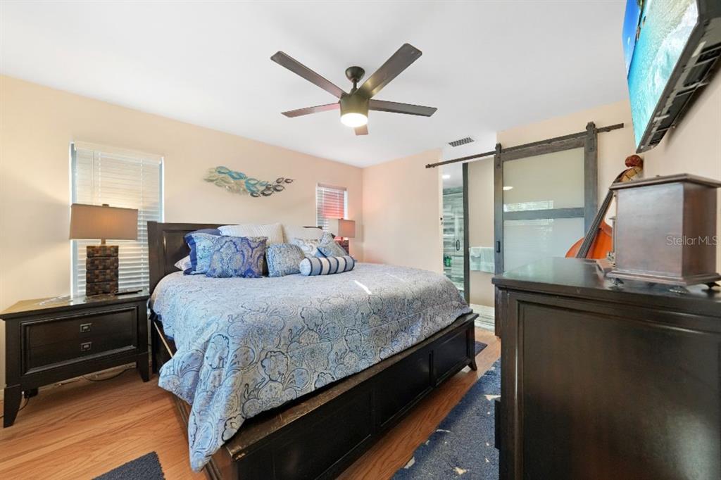 13064 Feldman Avenue Port Charlotte, FL 33981 - Photo 5 of 13 a bedroom with a bed and a ceiling fan