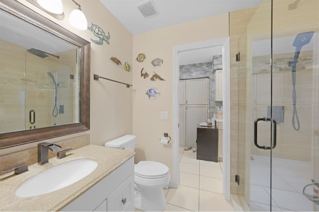 13064 Feldman Avenue Port Charlotte, FL 33981 - Photo 8 of 13 a bathroom with a granite countertop sink toilet and shower