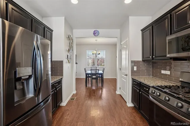 a kitchen with stainless steel appliances a refrigerator stove and microwave