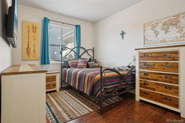 a bedroom with a bed and a dresser