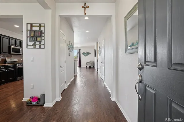 a view of hallway with wooden floor