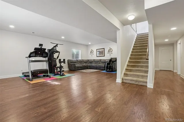 a view of a livingroom with wooden floor and stairs