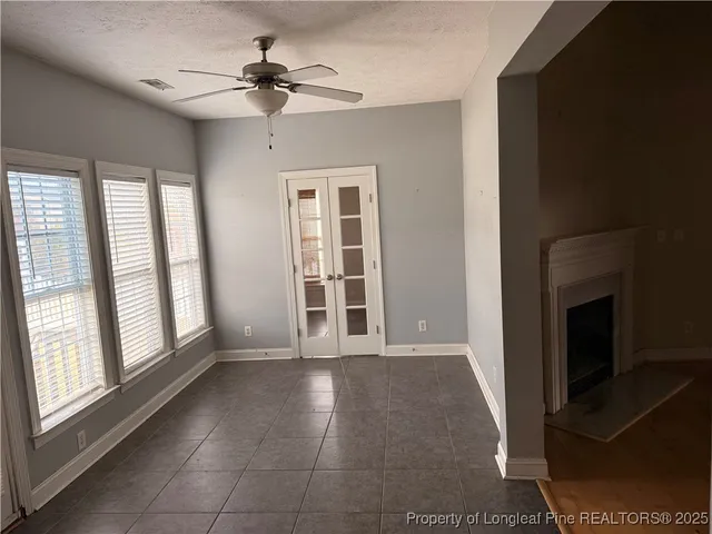 a view of a hallway with a refrigerator and a sink