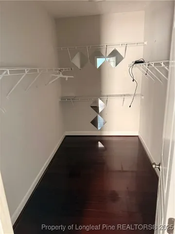 a view of an empty room with window and fireplace