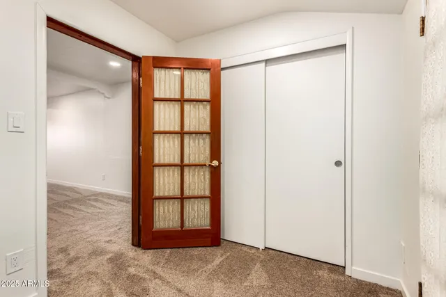 an empty room with windows and closet