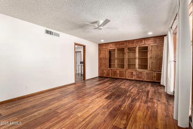 a view of wooden floor and windows in a room