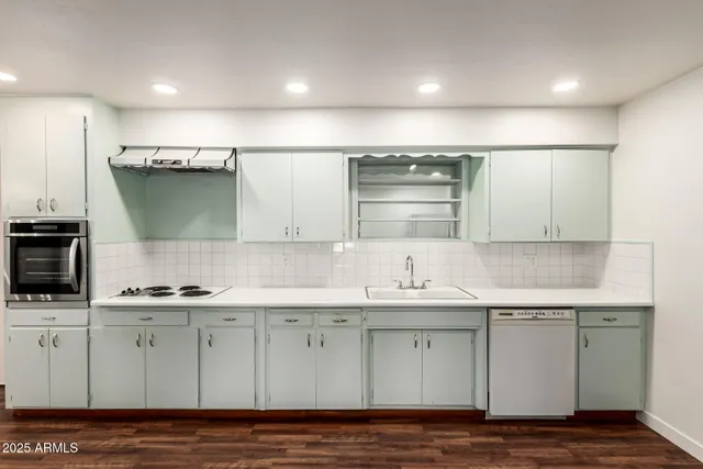 a kitchen with a sink cabinets and appliances