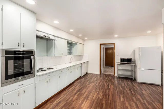 a kitchen with stainless steel appliances a refrigerator and a stove top oven
