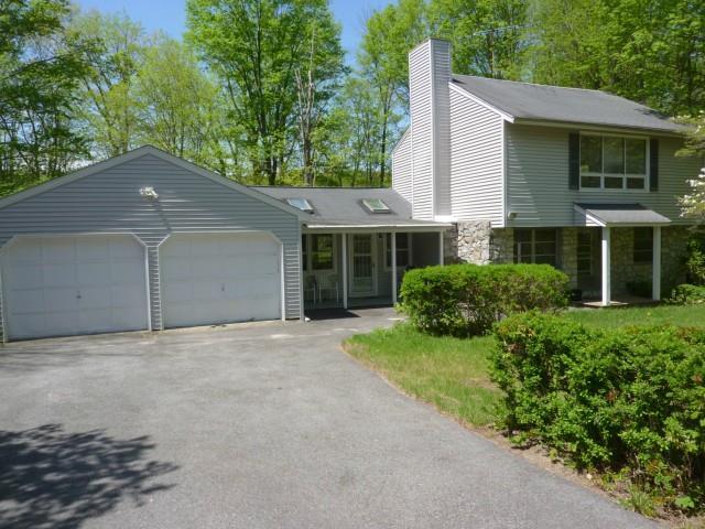 25 Crest Road Ridgefield, CT 06877 - Photo 1 of 1 a front view of a house with a yard and garage