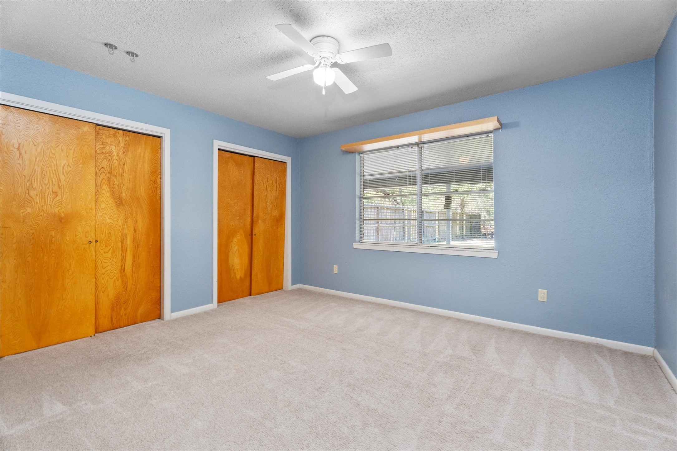 104 Anna Street Tomball, TX 77375 - Photo 14 of 32 The second bedroom on the other side of the bath at the back of the house could act as a second primary. It has views of the back porch and yard.