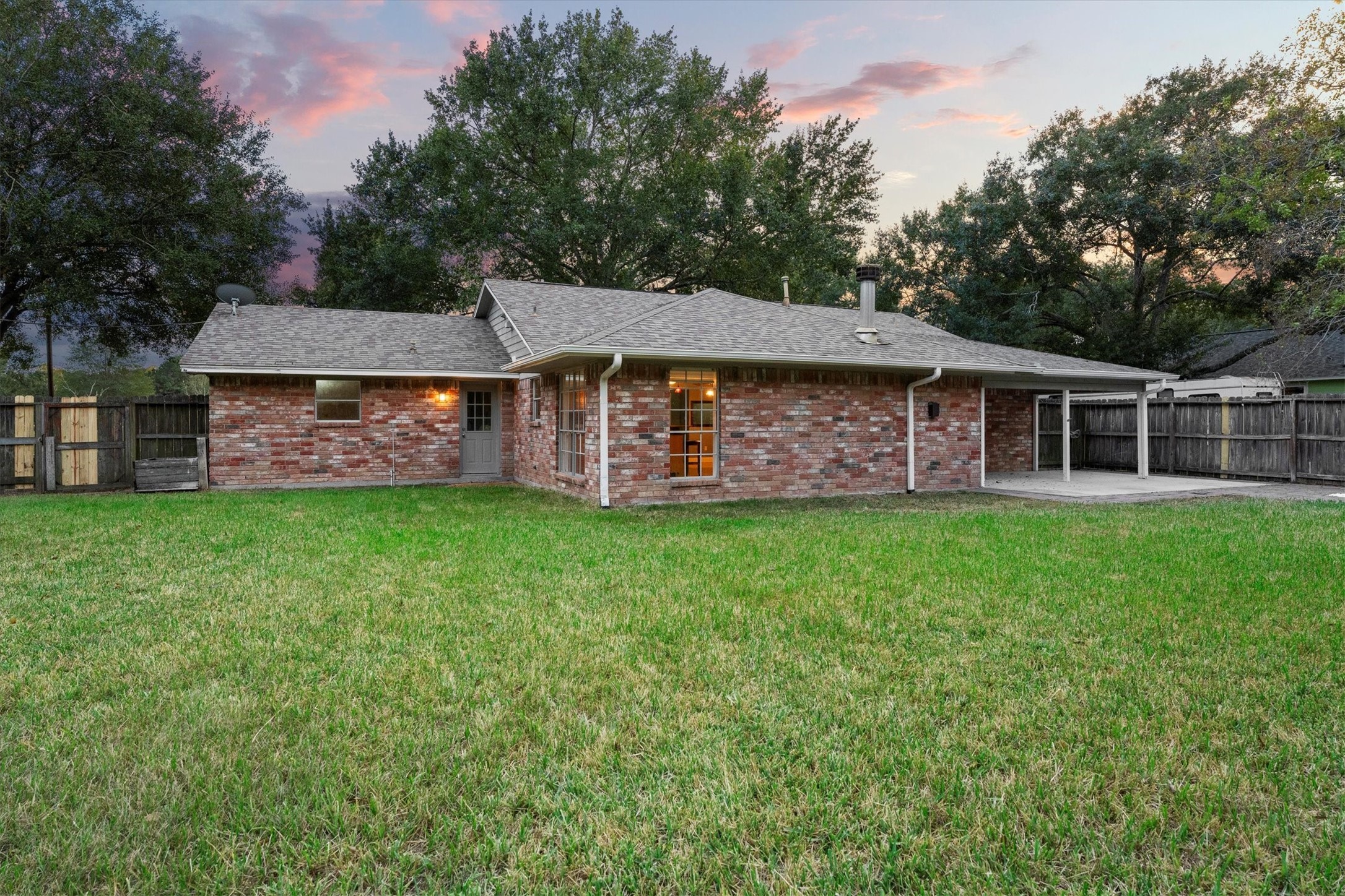 104 Anna Street Tomball, TX 77375 - Photo 21 of 32 View from next to the shed shows the spaciousness of this fenced backyard.