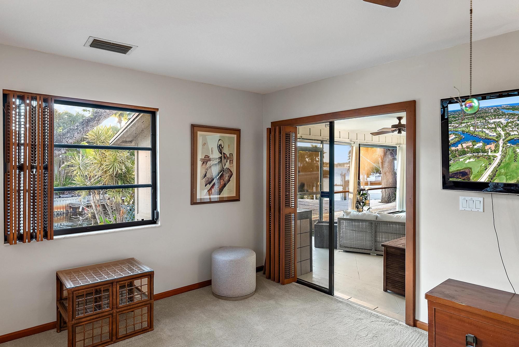 934 Penn Trail Jupiter, FL 33458 - Photo 47 of 54 a living room with furniture and a flat screen tv