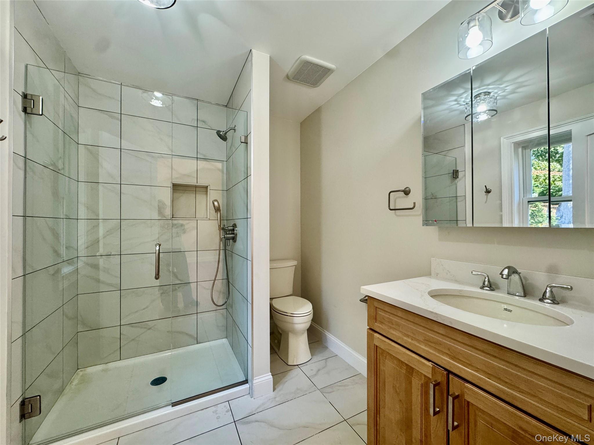 4 Webster Place Patterson, NY 12563 - Photo 11 of 42 a bathroom with a shower sink vanity and toilet