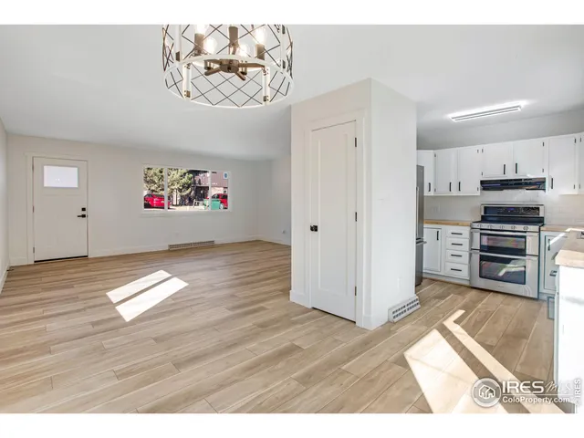 a view of empty room with wooden floor