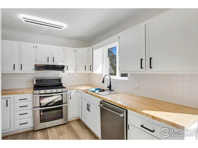 a kitchen with appliances cabinets and a sink