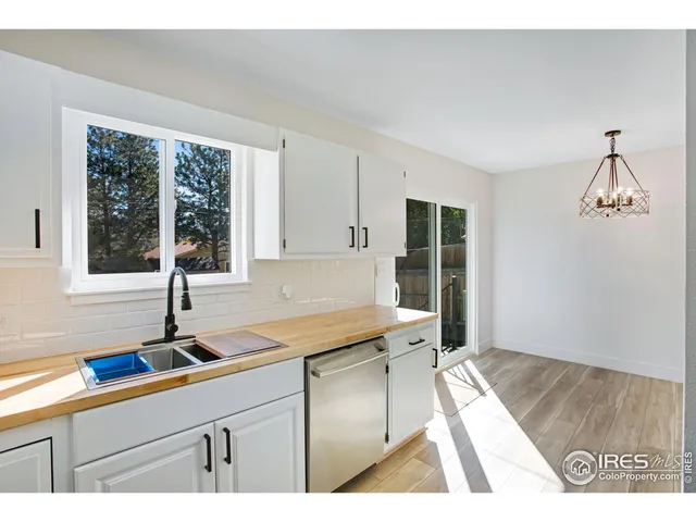 a kitchen with a sink a window and cabinets