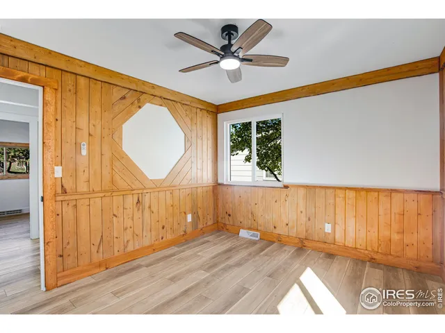 a view of a room with wooden floor and white walls