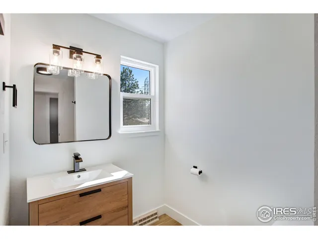 a bathroom with a sink and mirror
