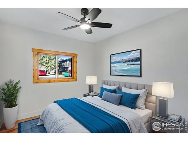 a bedroom with bed and painting on the wall