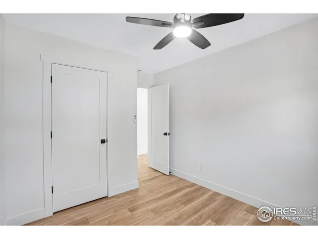 a view of an empty room and wooden floor
