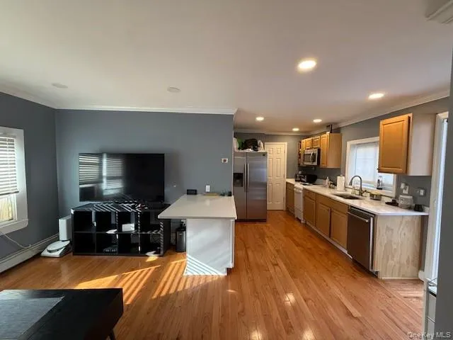 a large white kitchen with lots of counter space a sink and appliances